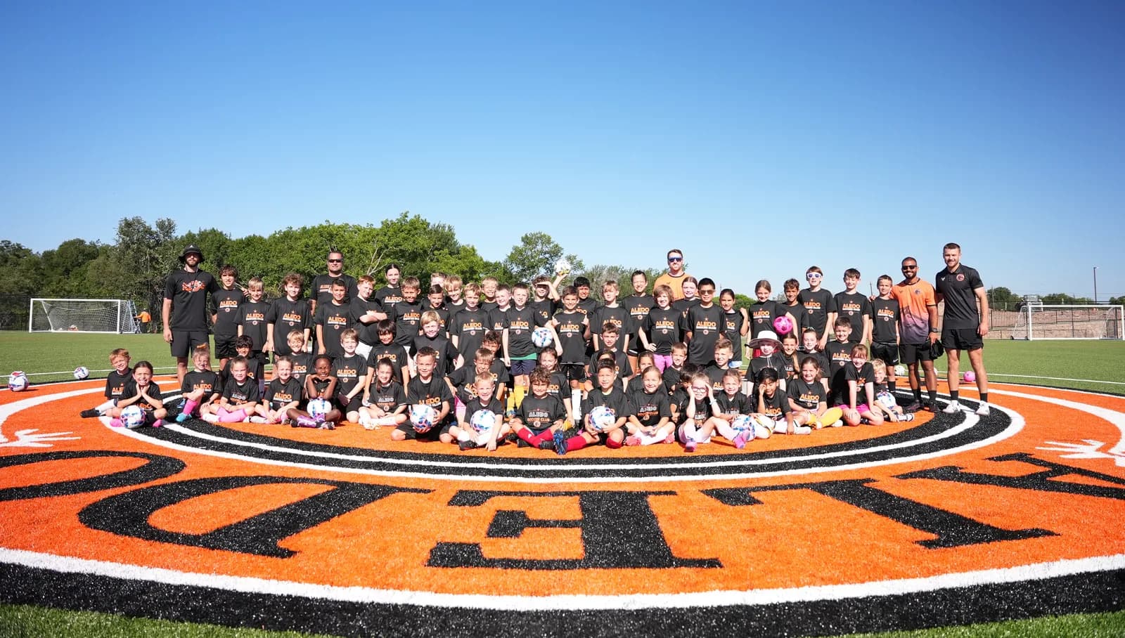 The full Aledo camp group gathered on the center circle at The Stable